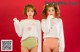 two young women standing next to each other in underwear