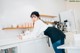 A woman standing in a kitchen next to a counter.