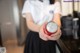 A woman holding a can of soda in her hands.